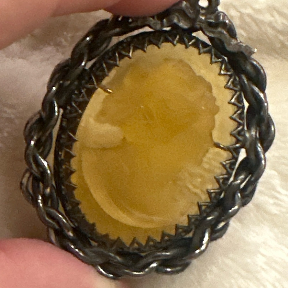 Elegant Amber Cameo Brooch with Silver Braided Frame